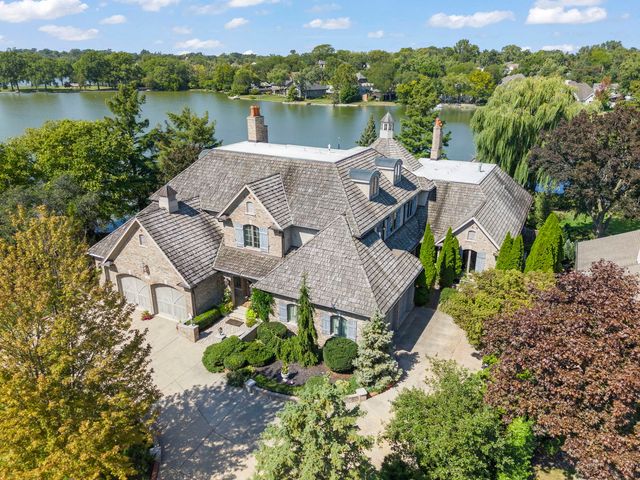 an aerial view of a house with a lake view