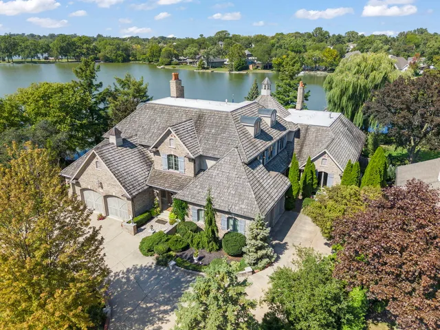an aerial view of a house with a lake view