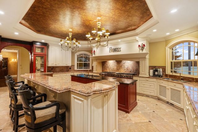 a kitchen with stainless steel appliances granite countertop a stove and a refrigerator