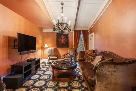 a bedroom with a bed and a chandelier