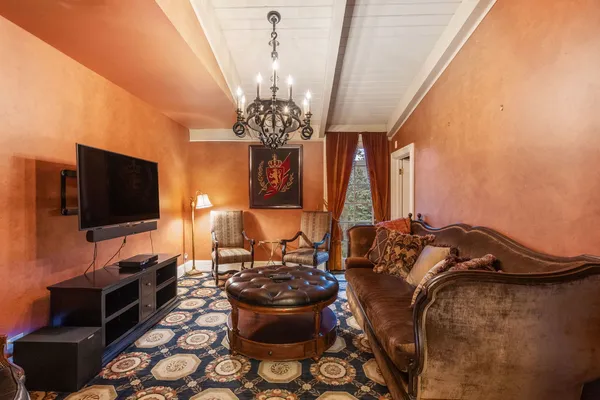 a bedroom with a bed and a chandelier