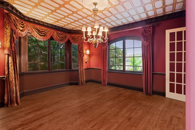a spacious bathroom with a granite countertop sink a mirror and shower