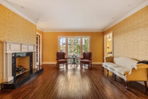 a bathroom with a granite countertop sink a mirror and shower