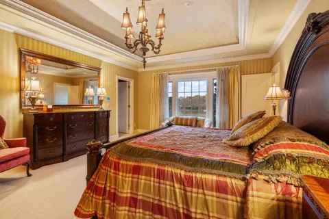 a living room with furniture a floor to ceiling window and a flat screen tv