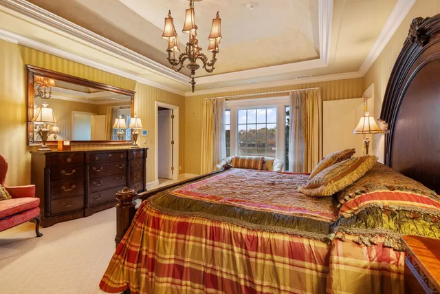 a living room with furniture a floor to ceiling window and a flat screen tv