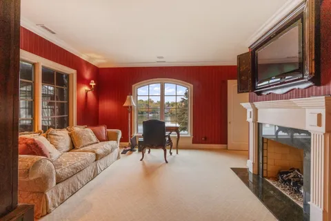 a room with lots of wooden furniture and painting on the wall