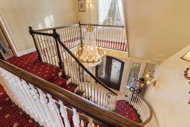 a view of a chandelier and wooden floor windows and chandelier
