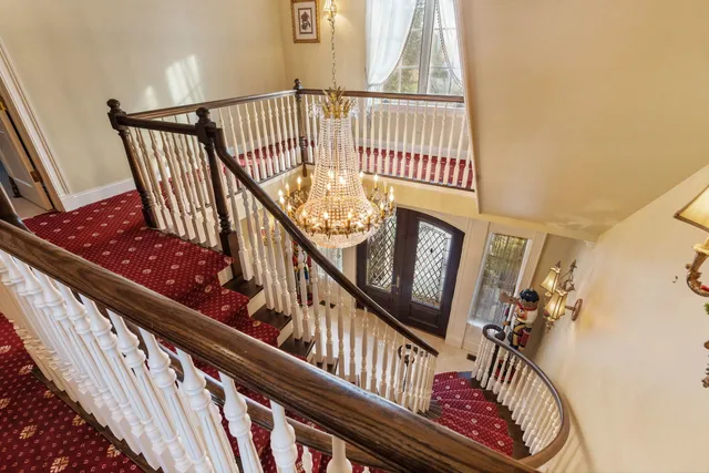 a view of a chandelier and wooden floor windows and chandelier