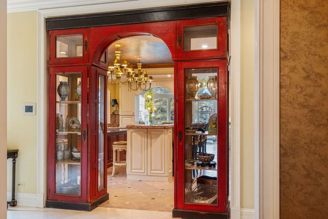 a kitchen with stove a sink and chairs