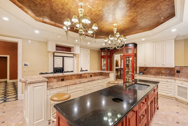 a large kitchen with kitchen island granite countertop a large window