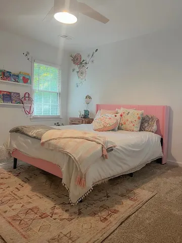 a bedroom with a bed and window