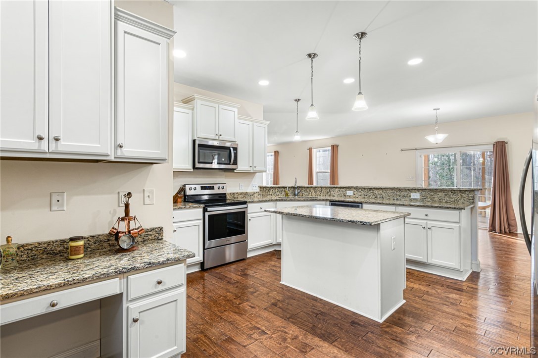 1602 Blakely Road Crozier, VA 23039 - Photo 15 of 44 a kitchen with kitchen island granite countertop a sink a counter space appliances and cabinets