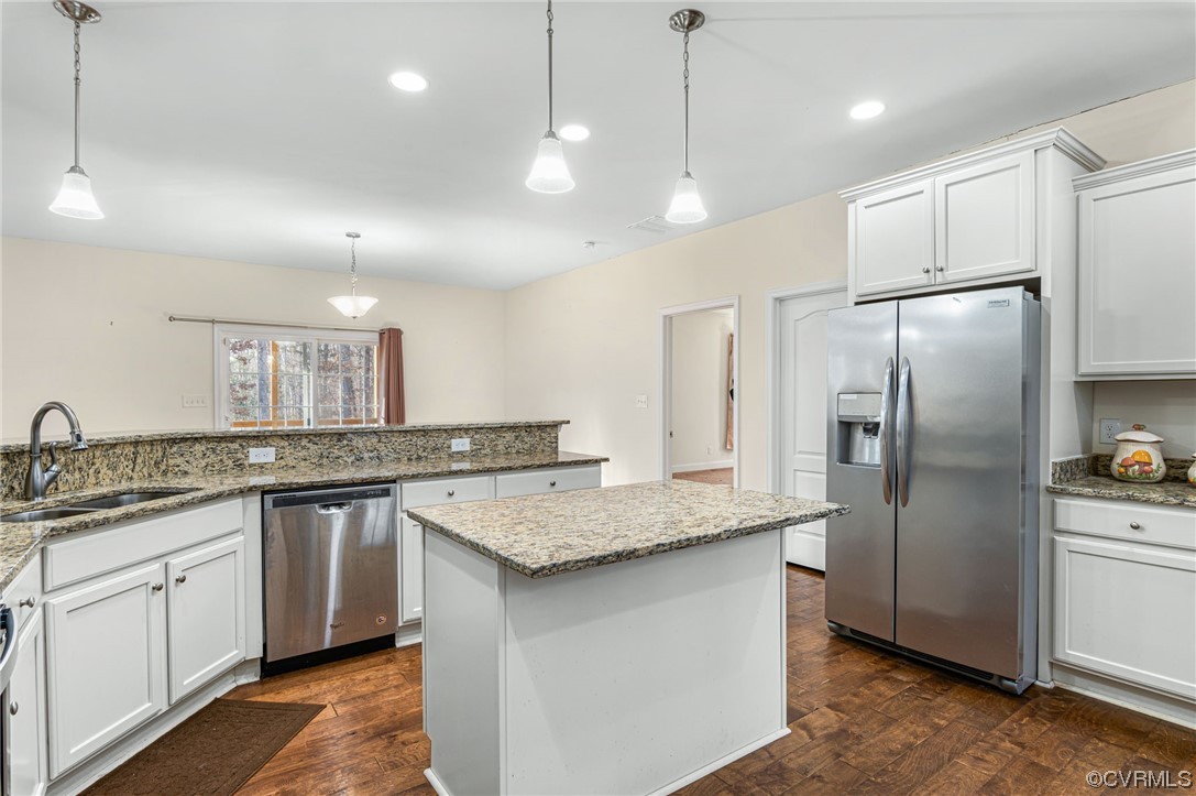 1602 Blakely Road Crozier, VA 23039 - Photo 16 of 44 a kitchen with stainless steel appliances granite countertop a sink a refrigerator a center island and a stove