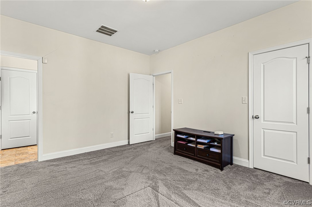 1602 Blakely Road Crozier, VA 23039 - Photo 23 of 44 an empty room with a cabinet and mirrors