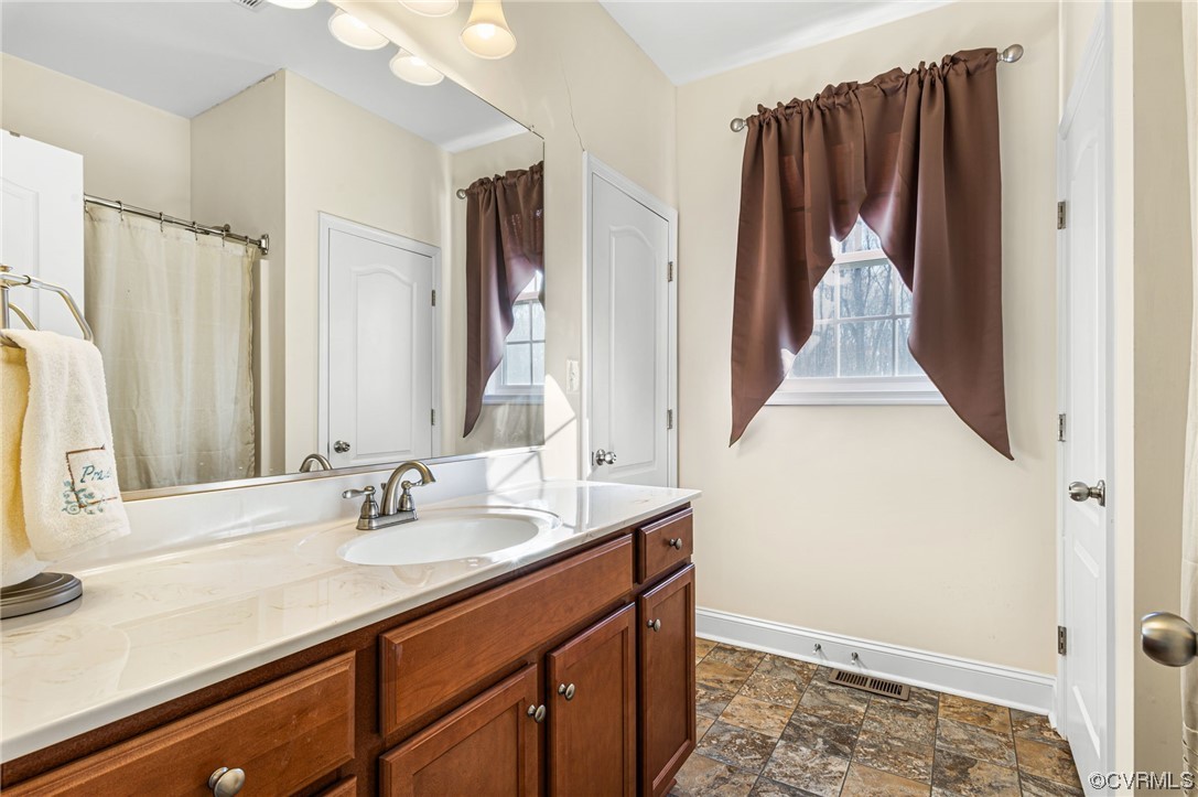 1602 Blakely Road Crozier, VA 23039 - Photo 25 of 44 a bathroom with a sink and a mirror