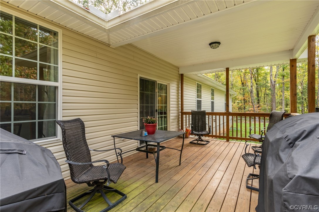1602 Blakely Road Crozier, VA 23039 - Photo 28 of 44 a balcony with wooden floor table and chairs