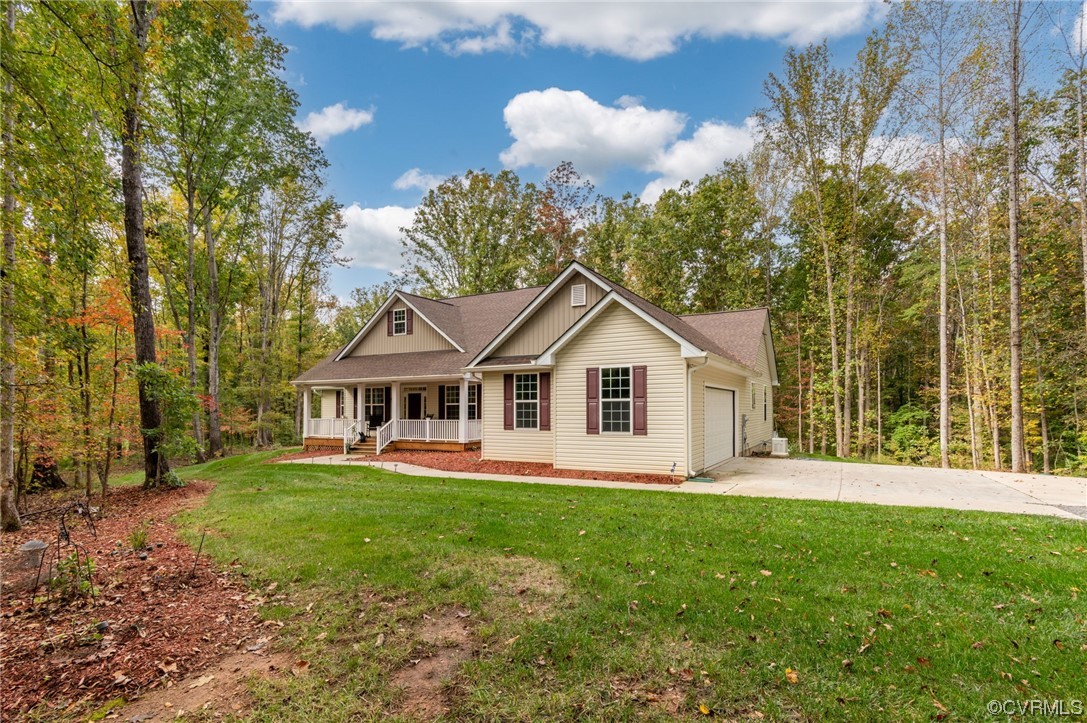 1602 Blakely Road Crozier, VA 23039 - Photo 33 of 44 a front view of a house with a yard and trees