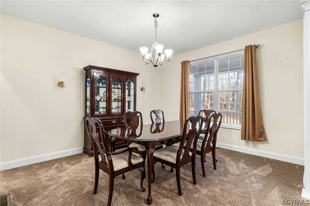 1602 Blakely Road Crozier, VA 23039 - Photo 6 of 44 a view of a dining room with furniture and a chandelier
