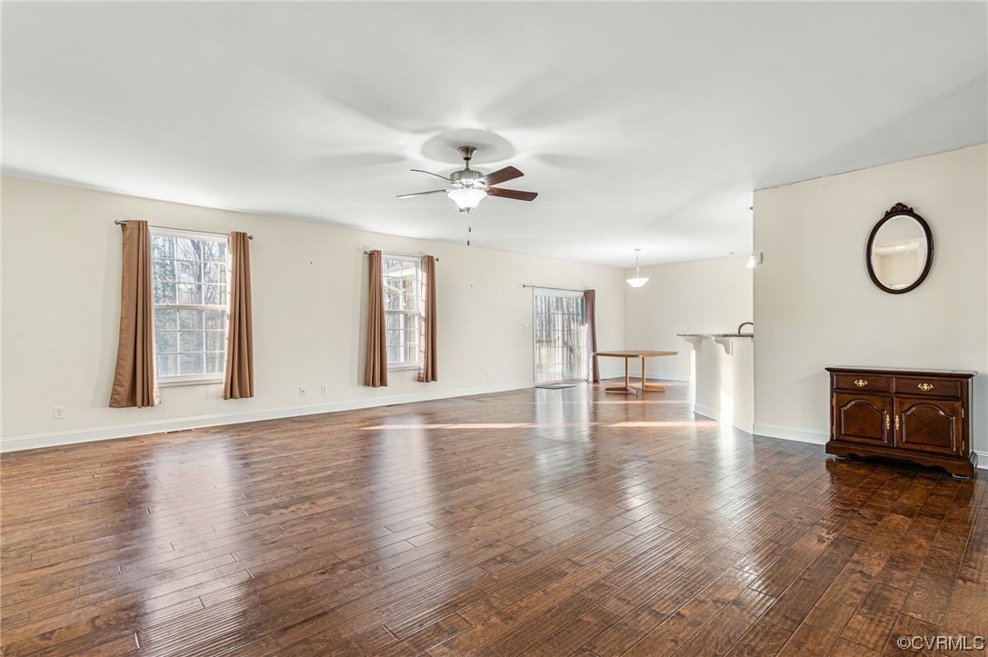 1602 Blakely Road Crozier, VA 23039 - Photo 8 of 44 a view of a livingroom with furniture wooden floor and a ceiling fan