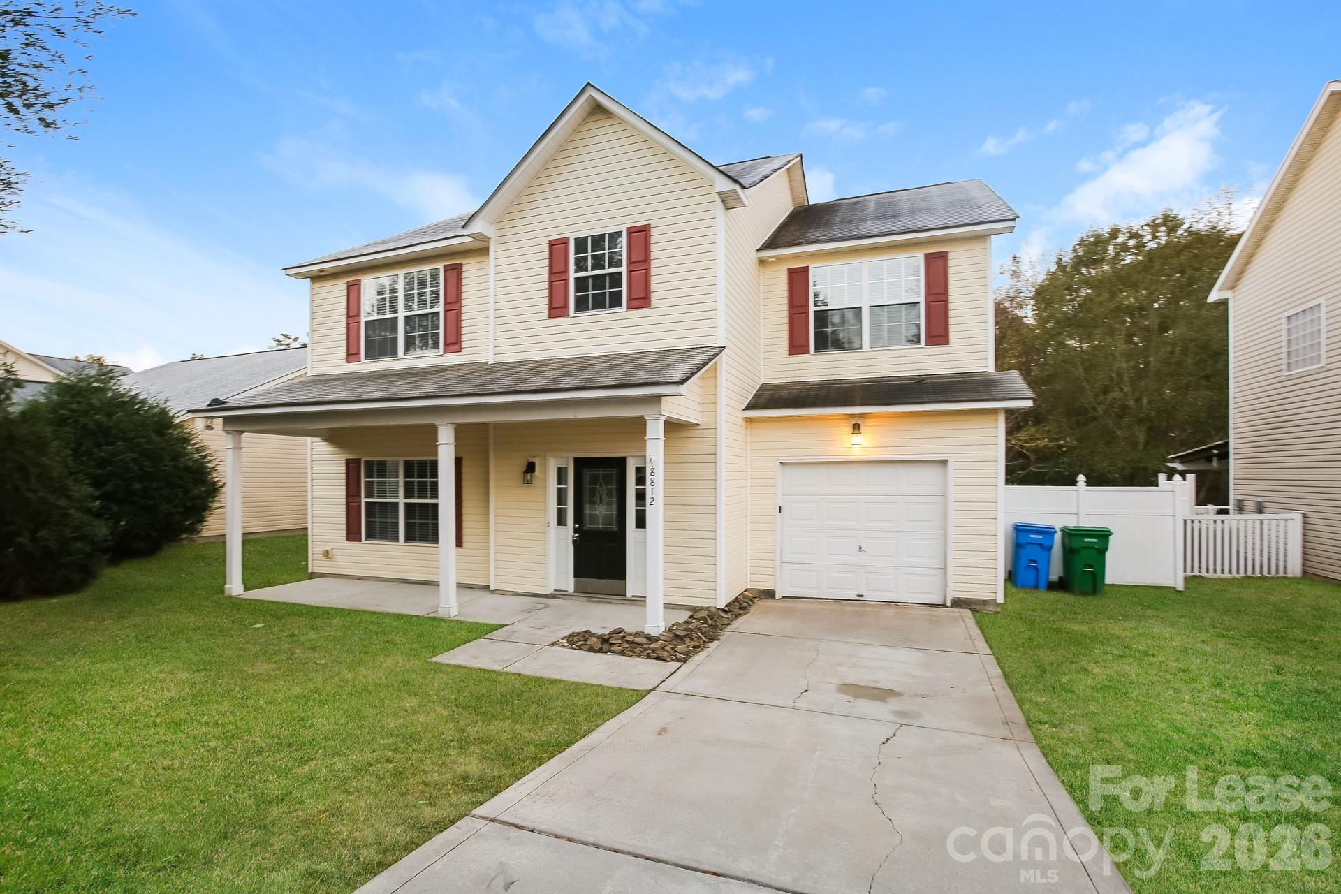 8812 Cornwall Street Locust, NC 28097 - Photo 2 of 15 a view of a white house with a big yard and potted plants