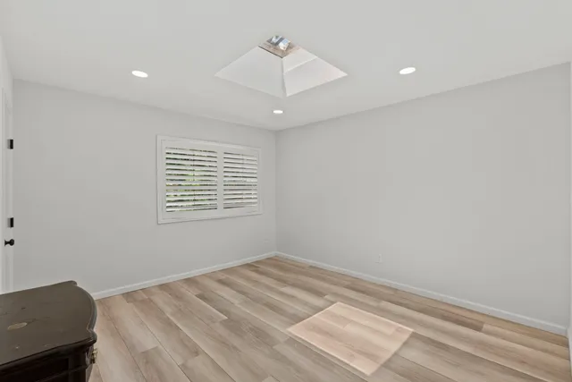 a view of a room with wooden floor and windows
