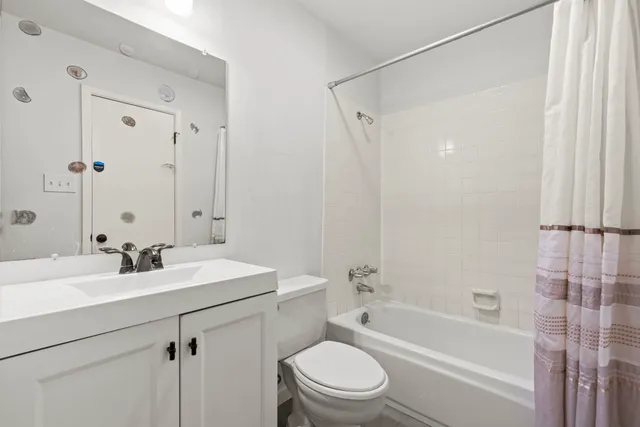a bathroom with a sink mirror toilet and bathtub