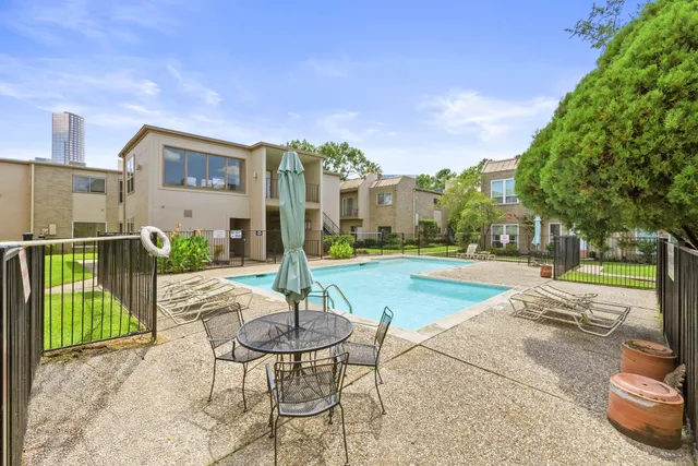 a swimming pool with outdoor seating and yard
