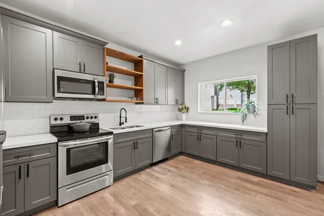 a kitchen with a sink stove and microwave