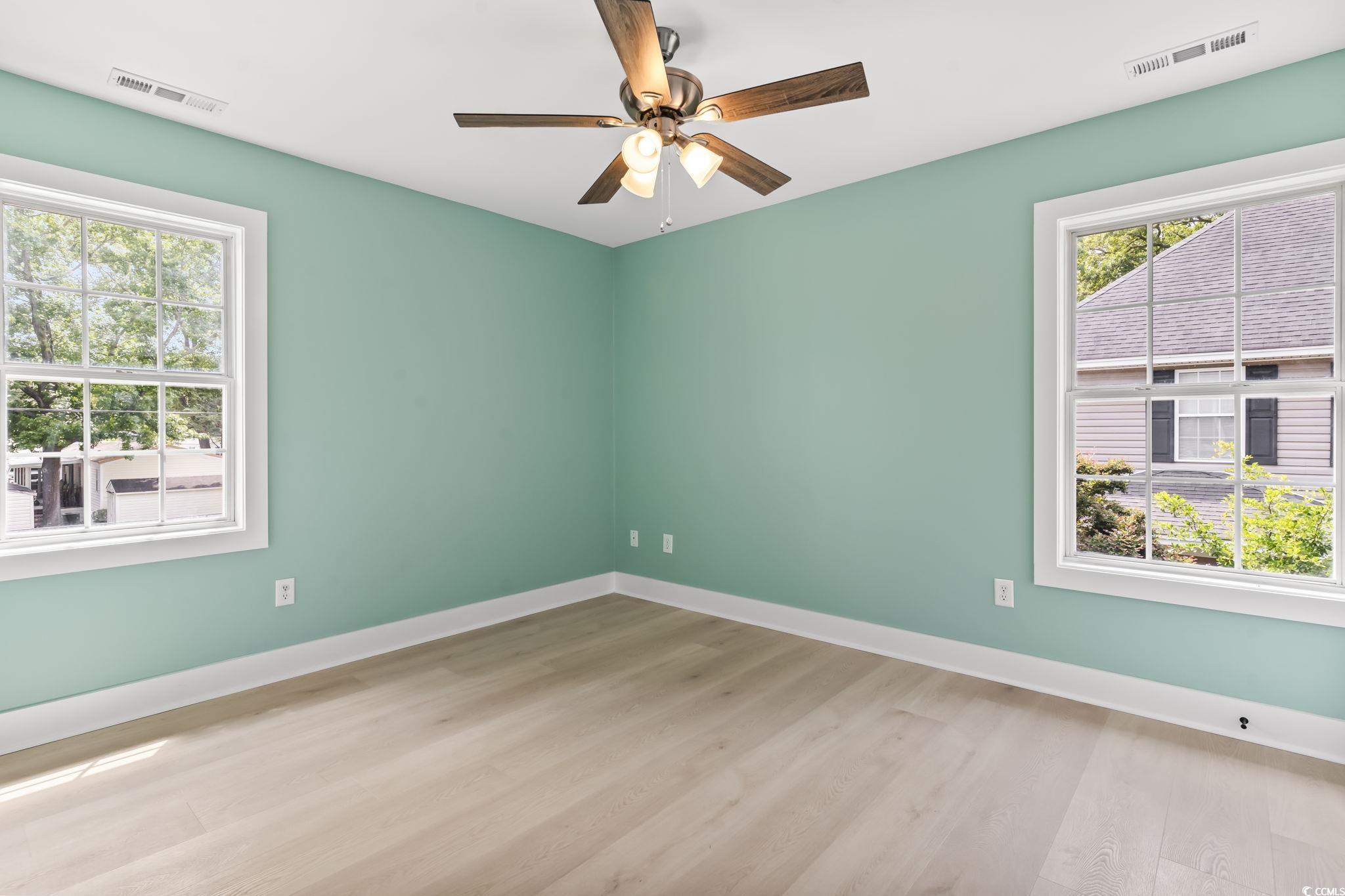 540 Boundary Avenue Murrells Inlet, SC 29576 - Photo 16 of 40 Empty room featuring ceiling fan and hardwood / wo