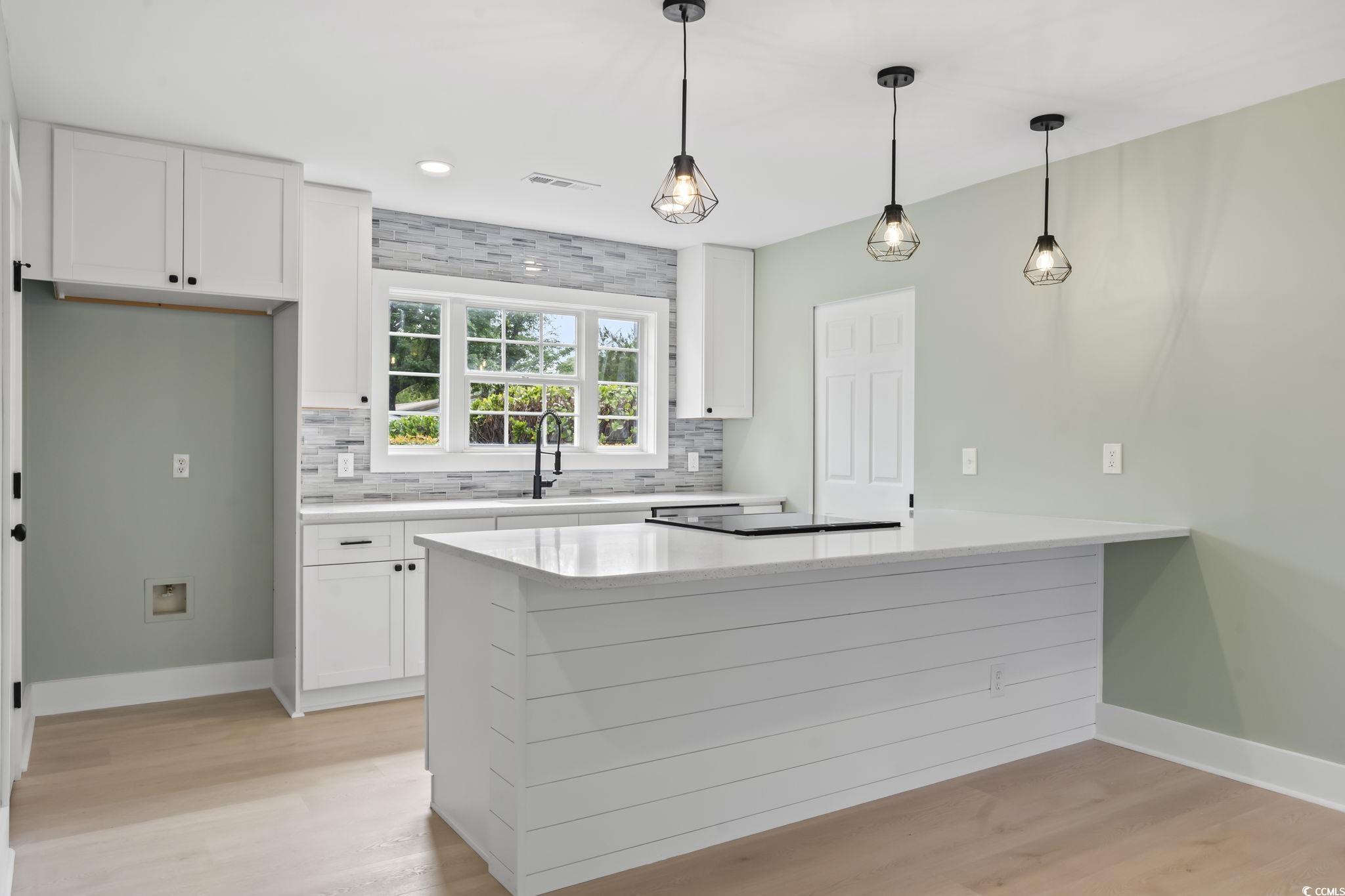 540 Boundary Avenue Murrells Inlet, SC 29576 - Photo 24 of 40 Kitchen with tasteful backsplash, white cabinetry,