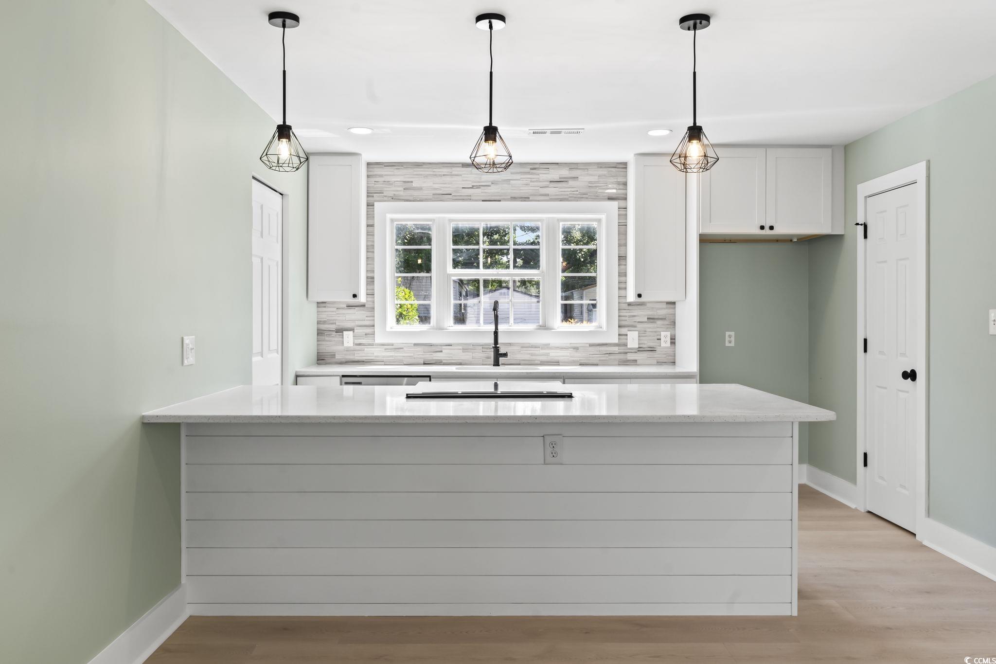 540 Boundary Avenue Murrells Inlet, SC 29576 - Photo 6 of 40 Kitchen featuring white cabinetry, tasteful backsp