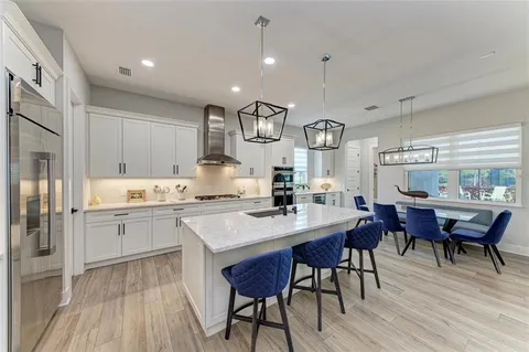 a bathroom with a granite countertop sink a toilet and shower