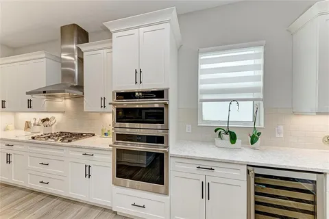 a bathroom with a granite countertop sink and a bathtub