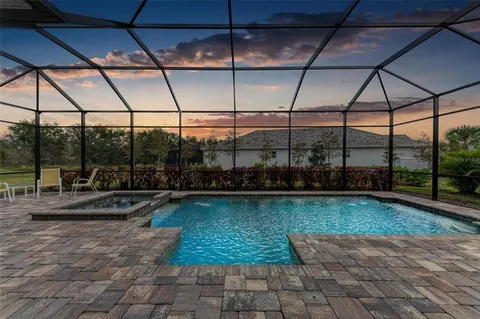 a view of a swimming pool with a yard