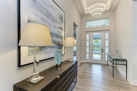 a living room with furniture and a chandelier
