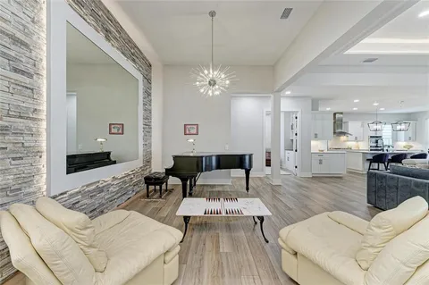 a living room with furniture and a chandelier