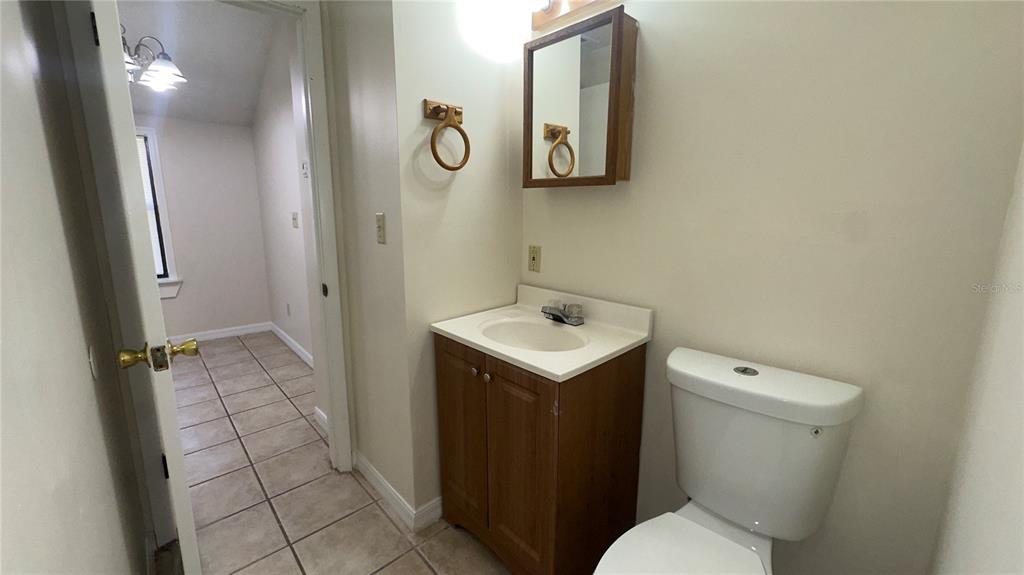616 Massachusetts Avenue, Unit A St. Cloud, FL 34769 - Photo 14 of 15 a bathroom with a sink toilet and shower
