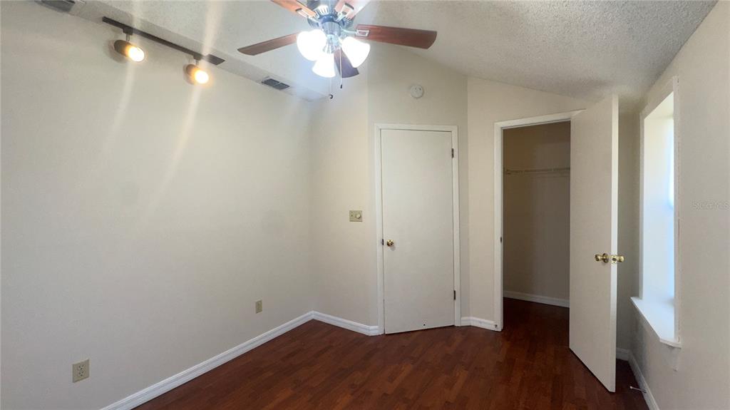 616 Massachusetts Avenue, Unit A St. Cloud, FL 34769 - Photo 6 of 15 a view of an empty room with wooden floor