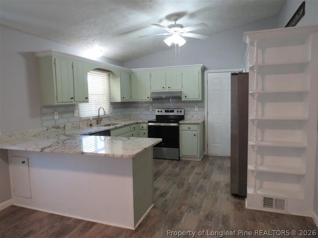 760 Ashbrook Road Fayetteville, NC 28314 - Photo 3 of 13 a kitchen with stainless steel appliances granite countertop a refrigerator a stove a sink and a refrigerator