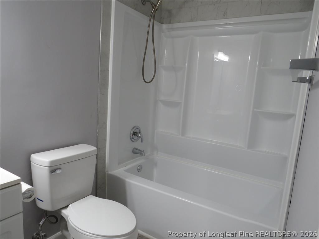 760 Ashbrook Road Fayetteville, NC 28314 - Photo 6 of 13 a white toilet sitting next to a bath tub and shower