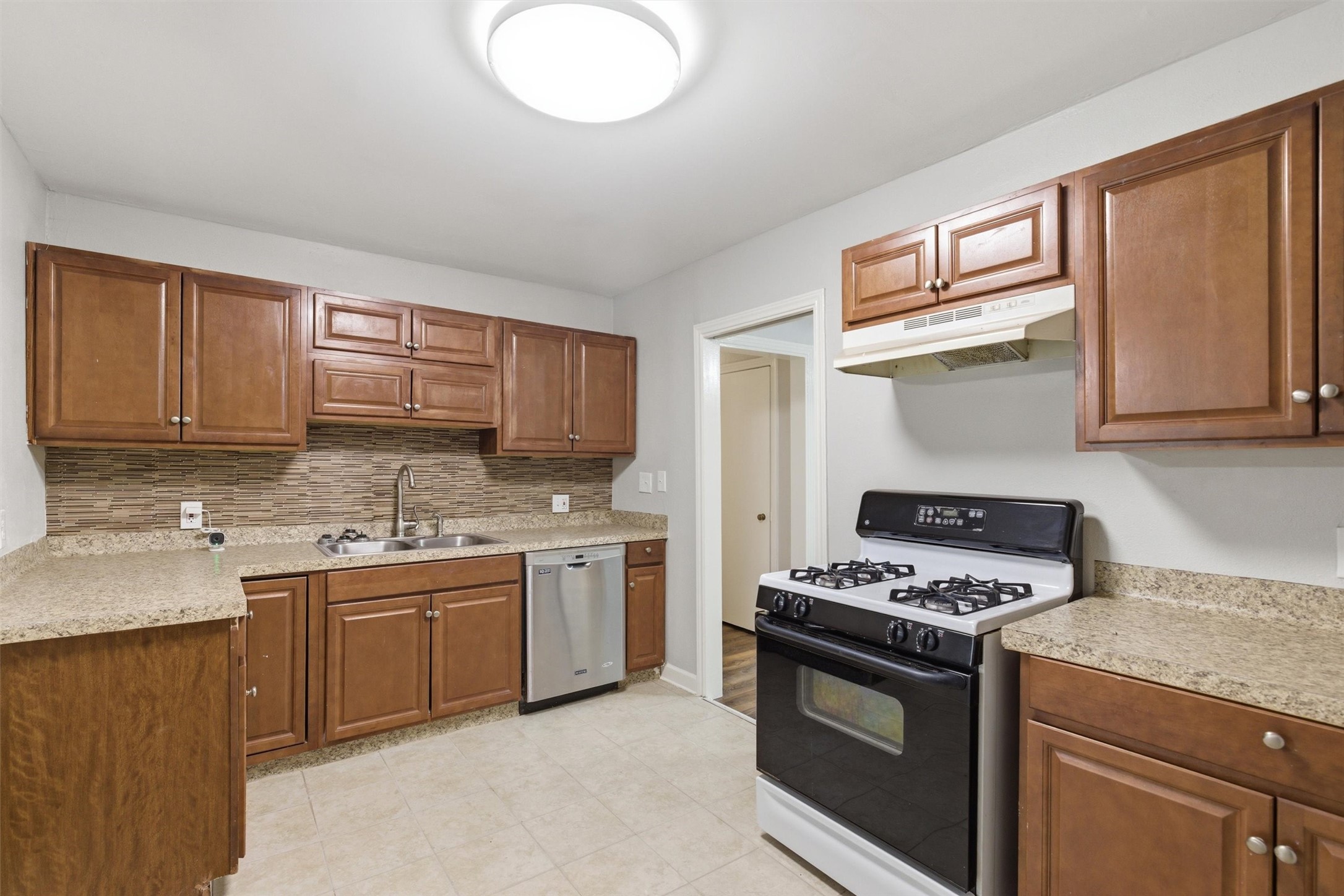 3615 Alberta Street Houston, TX 77021 - Photo 4 of 16 a kitchen with stainless steel appliances granite countertop a sink stove and cabinets