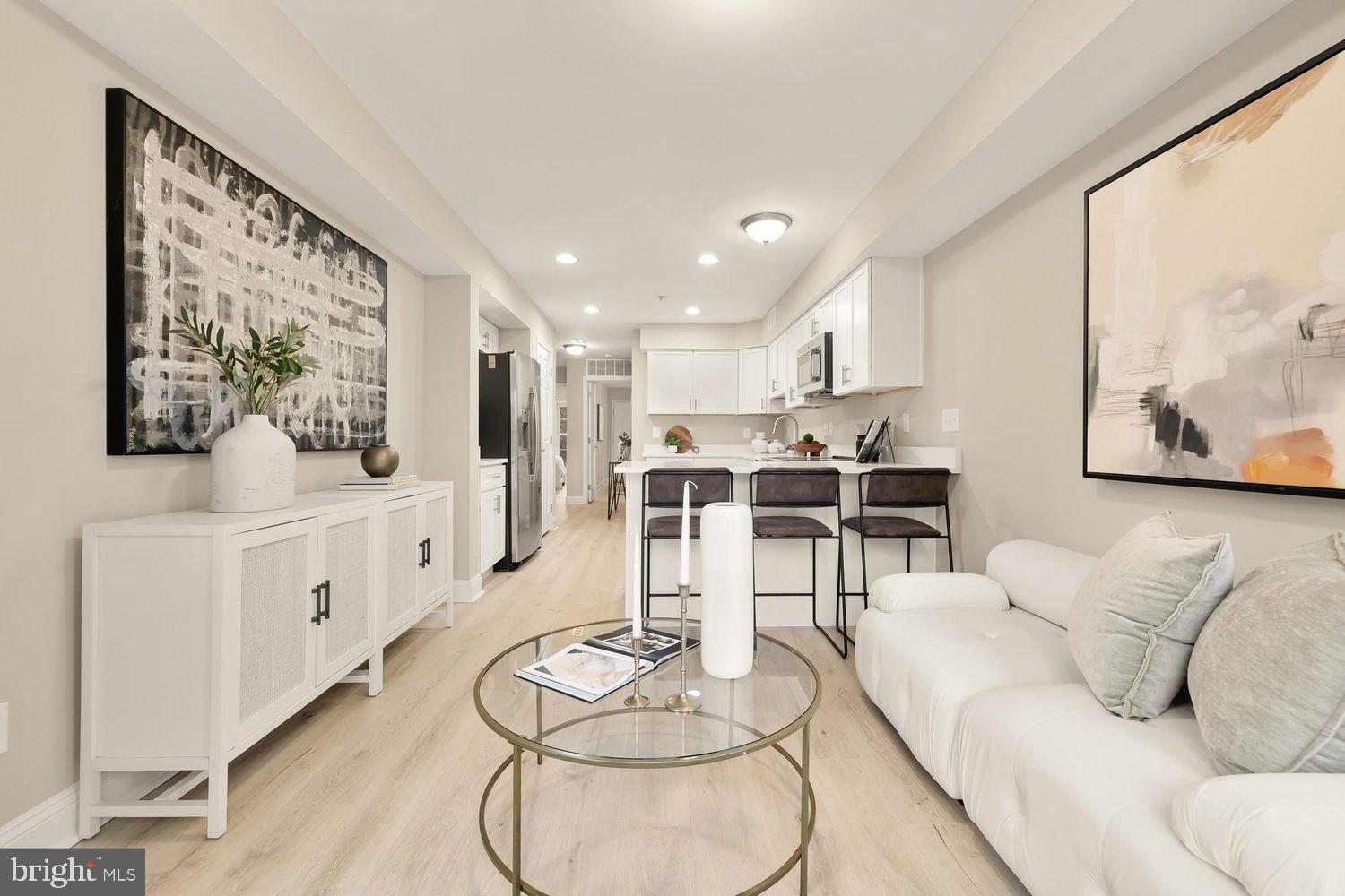 1753 W Street Southeast, Unit B Washington, DC 20020 - Photo 2 of 27 a living room with furniture and kitchen view