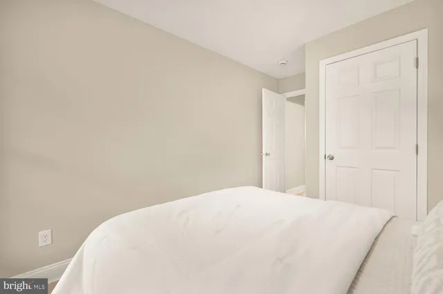 a large white bed in a white room