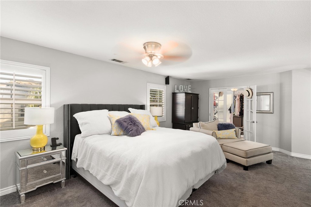 29602 Cool Meadow Drive Menifee, CA 92584 - Photo 12 of 31 a bedroom with a bed and a chandelier