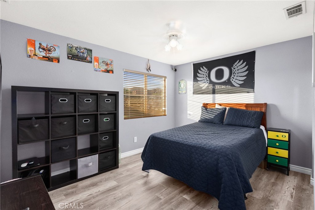 29602 Cool Meadow Drive Menifee, CA 92584 - Photo 18 of 31 a bedroom with a bed and a window