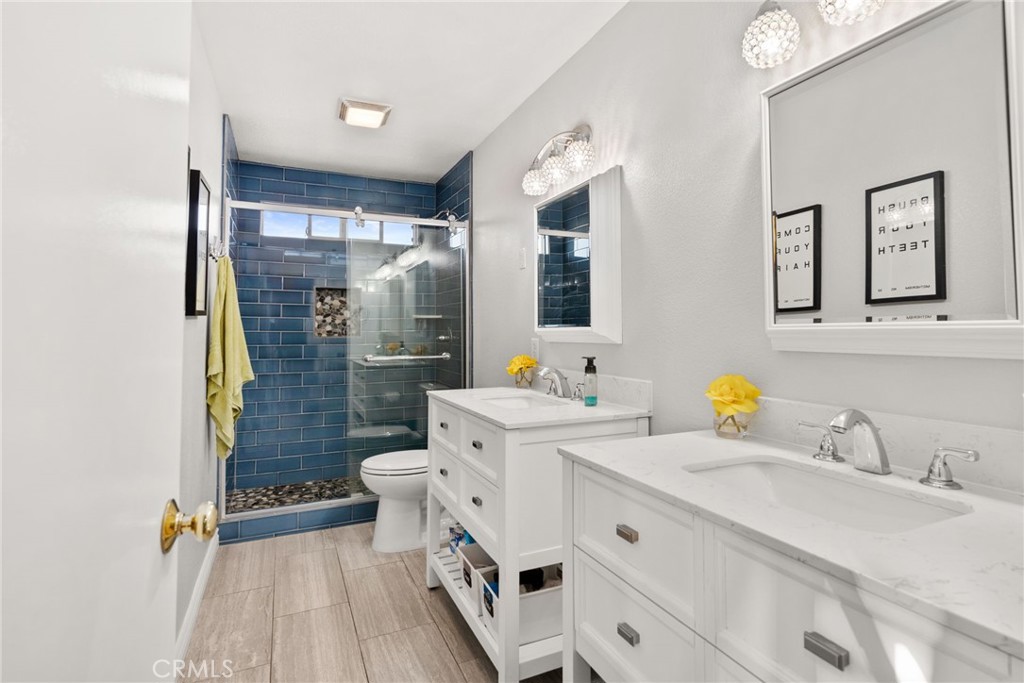 29602 Cool Meadow Drive Menifee, CA 92584 - Photo 20 of 31 a spacious bathroom with a shower sink and mirror