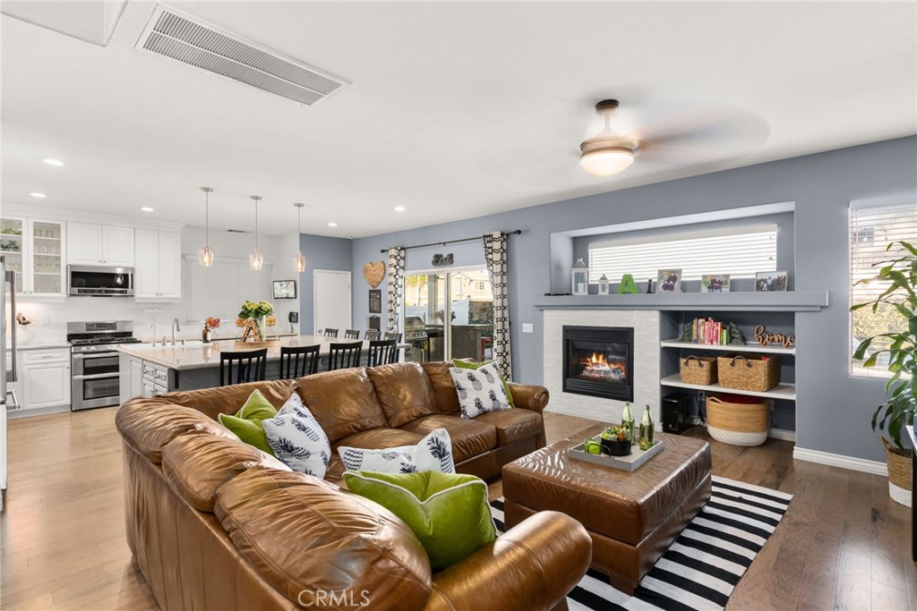 29602 Cool Meadow Drive Menifee, CA 92584 - Photo 2 of 31 a living room with fireplace furniture and a large window