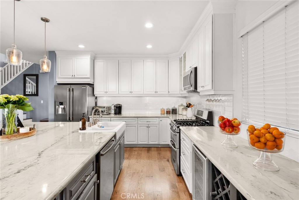 29602 Cool Meadow Drive Menifee, CA 92584 - Photo 8 of 31 a kitchen with stainless steel appliances granite countertop a sink stove and refrigerator