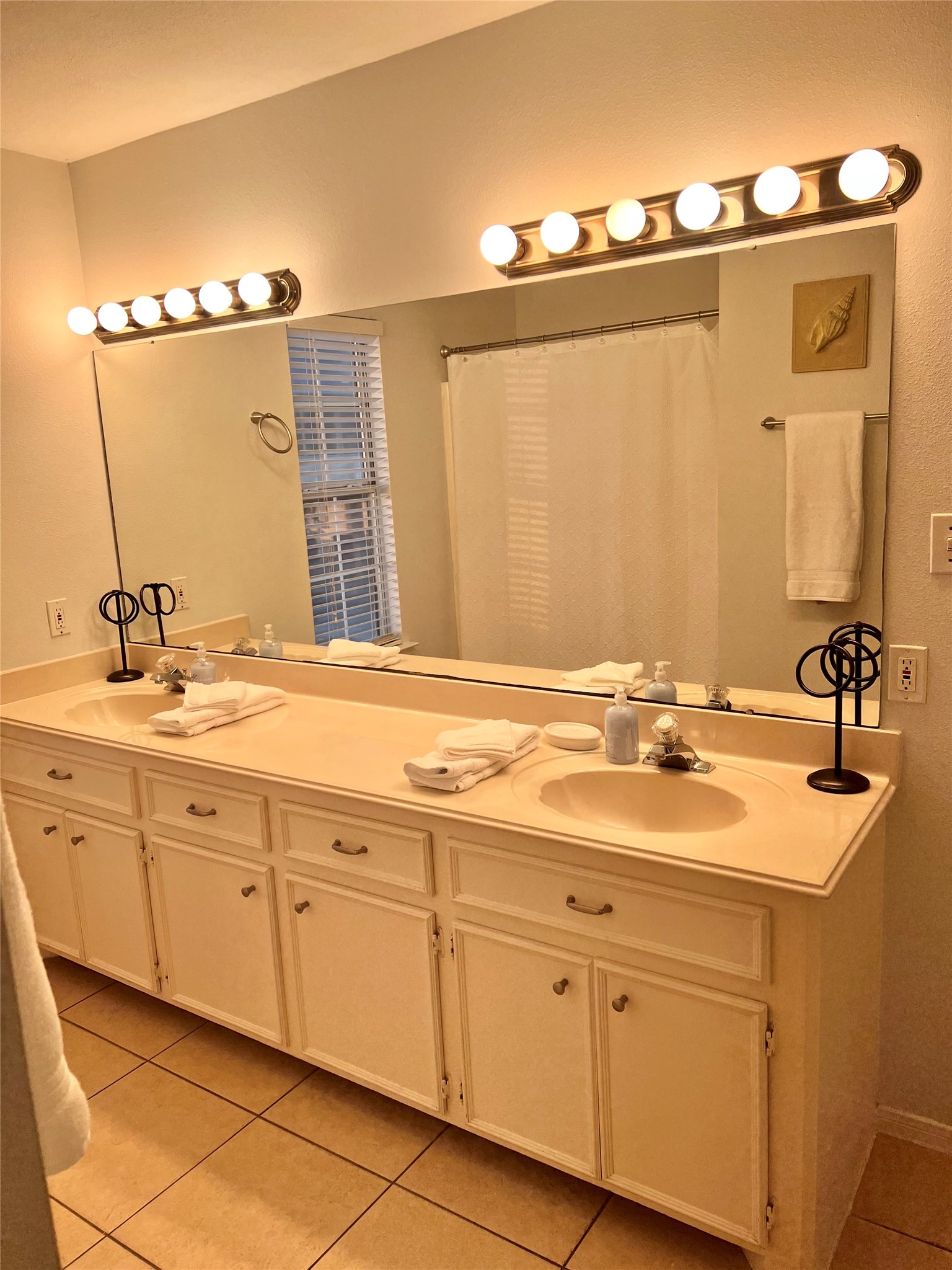 125 Marlin Avenue Freeport, TX 77541 - Photo 5 of 11 a bathroom with a double vanity sink and mirror