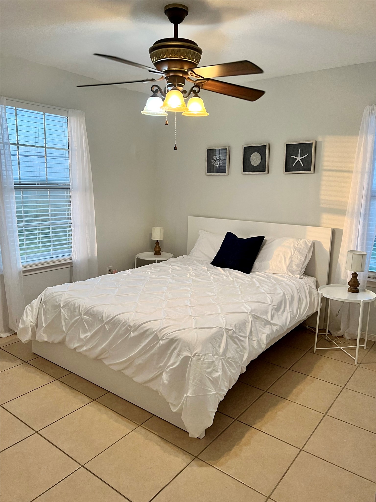 125 Marlin Avenue Freeport, TX 77541 - Photo 7 of 11 a bedroom with a bed and a chandelier